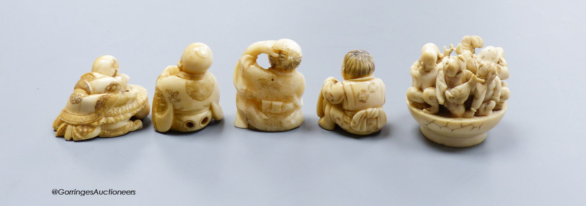 Five Japanese carved ivory netsukes, Meiji period, including an example of the seven gods of happiness, tallest 5cm